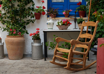 Wooden rocking chair in Spanish courtyard.