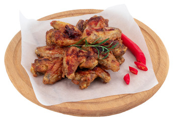 Grilled chicken wings on wooden cutting board isolated on white background