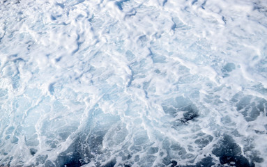 Fototapeta na wymiar Close-up of sea waves and white foam natural background.