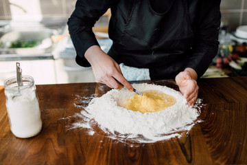 Obraz na płótnie Canvas Chef making fresh pasta in the kitchen