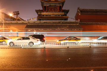 Night traffic in front of a traditional temple in Beijing, China