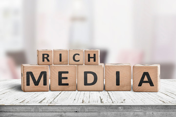 Rich media word sign on a wooden desk
