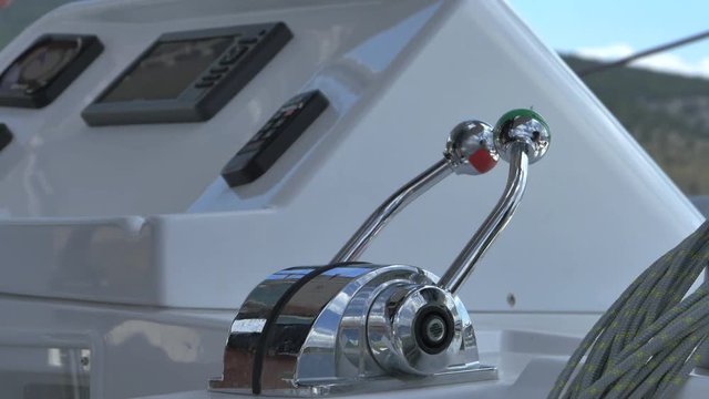 The captain of the ship presses the speed lever. Journey to Greece on sailing catamarans and yachts