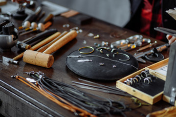 messy jeweler's table. useful tools for repairing materials, close up photo.