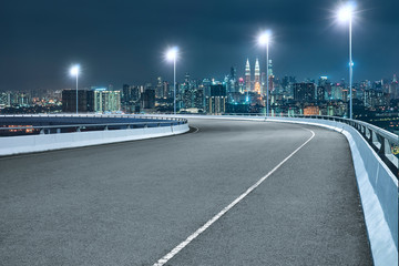 Fototapeta na wymiar High speed corner overpass asphalt road with modern cityscape , night scene .