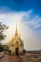 Fototapeta premium Beautiful white buddhist pavilion on the hilltop with blue sky background at Wat Phraputthachai temple, Saraburi, Thailand. This temple is public for entry and tourist can enjoy the 360-degree view.