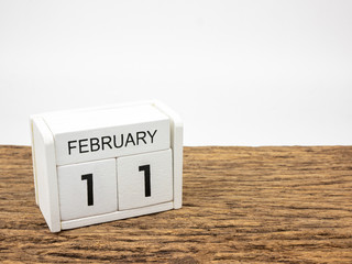 February 11 white cube wooden calendar on vintage wood and white background with winter day, Copyspace for text