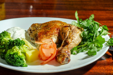 traditional fried chicken with vegetables sauce and greens