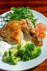 traditional fried chicken with vegetables sauce and greens