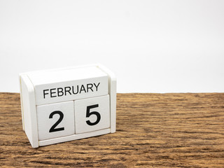 February 25 white cube wooden calendar on vintage wood and white background with winter day, Copyspace for text