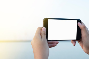 A hand take a picture with smartphone and white screen on smartphone