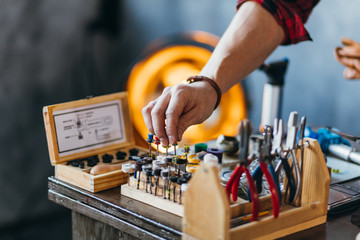 man holding polishing tools at workplace. close up cropped photo