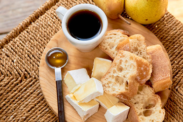 Rustic breakfast. Espresso and cheese plate. Brie, pears, walnuts, baguette bread