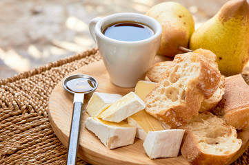 Rustic breakfast. Espresso and cheese plate. Brie, pears, walnuts, baguette bread