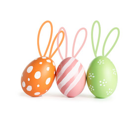 Set of colorful eggs with Easter bunny ears on white background