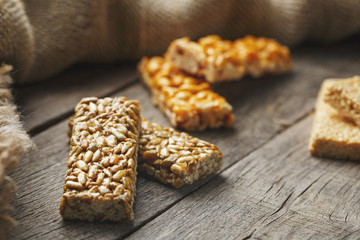 Casinac from sunflower seeds on old vintage background with burlap cloth. Country style. Delicious sweets from seeds of sunflower, sesame and peanuts, covered with shiny glaze
