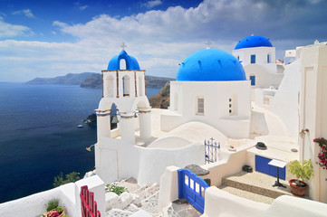 Landscape with greek white church overlooking the sea, Oia Town, Santorini Island, Greece.