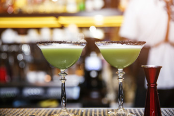 Glasses of tasty cocktail on bar counter