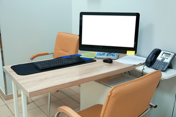 Doctor's workplace with computer in modern clinic. Space for design