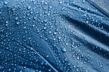 Water drops on the fabric. Rain Water droplets on blue fiber waterproof fabric. Water drops pattern...