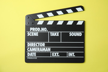 Naklejka premium Clapperboard on color background, top view. Cinema production
