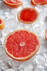 Fresh grapefruit slices on pile of ice cubes