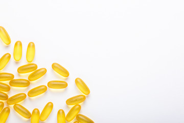 Omega 3 capsules on white background Fish oil Yellow softgels Vitamin D, E, A supplement Concept of healthcare
