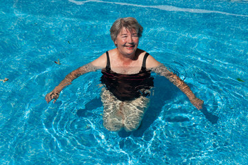 Senior woman smiling in a pool