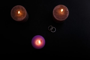 broken love and triangle composition with candles rings