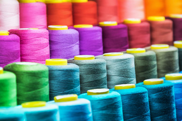 different color spools of thread for the textile industry. background