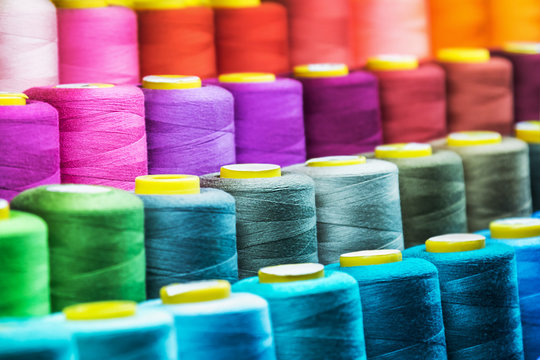 Set of colored threads for sewing on coils. Pile of big colorful spools of  thread. Colored thread spools of thread large class, textiles, background  Stock Photo - Alamy