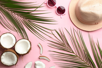 Flat lay composition with coconuts and beach objects on color background