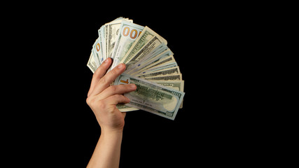 Fan of dollars in a male hand on a black background
