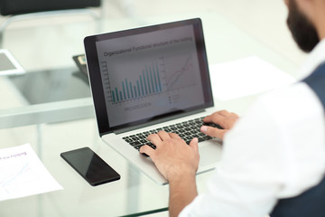 close up.businessman typing on laptop in office