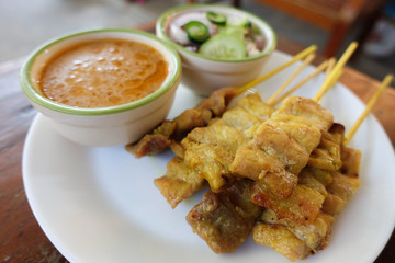 Pork satay or thai style grilled pork with peanut sauce and sweet and sour sauce
