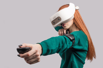 Active beautiful female player with long red hair , being excited watching virtual reality play...