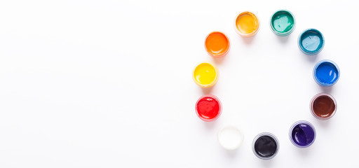 Multicolored gouache on a white background Circle shape Isolated Paints in containers Top view Banner Horizontal