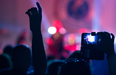 Fototapeta na wymiar People at concert shooting video or photo