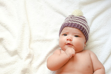 Newborn baby wear handmade fabric hat on towel with sunlight shading