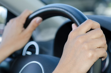 Woman Holding a Steering Wheel Inside a Car.