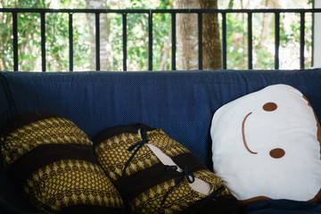 Smiling face pillow on blue sofa bed