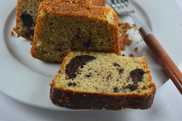 banana cake on a white plate with a fork next to it