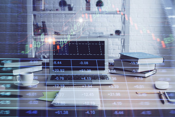 Double exposure of stock market chart and office desktop on background. financial strategy concept.