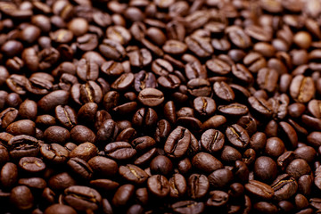 Aroma roasted coffee beans, brown banner background. Soft focus close up.