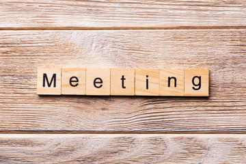 MEETING word written on wood block. MEETING text on wooden table for your desing, concept