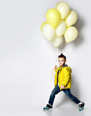 Stylish little boy holding air balloon isolated on white