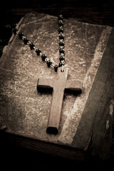 Old holy bible and wooden cross