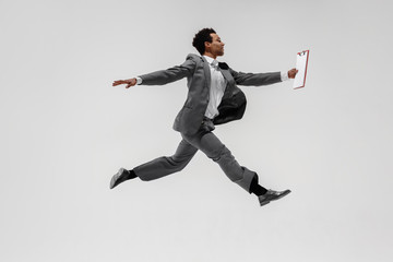 Fototapeta na wymiar Happy businessman dancing in motion isolated on white studio background. Flexibility and grace in business. Human emotions concept. Office, success, professional, happiness, expression concepts