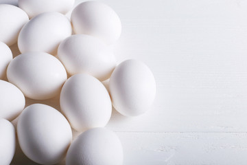 White eggs pattern, on a wooden table.