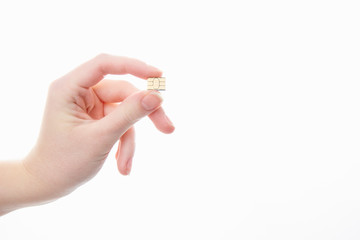 girl holding a nano SIM card on a white background